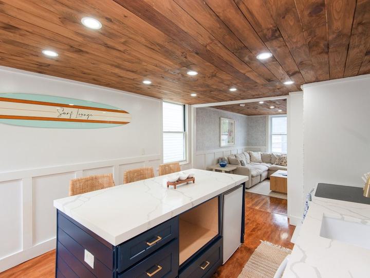 Kitchen island under a wood-plank ceiling